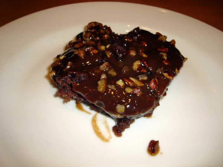 a piece of chocolate dessert sitting on top of a white plate