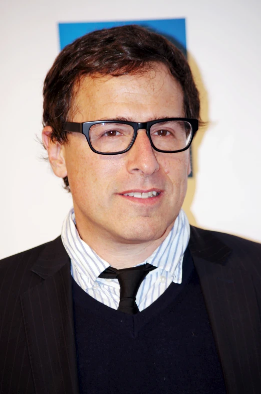 man wearing glasses with tie looking to the side