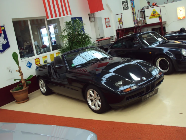 some black sports cars in a big room