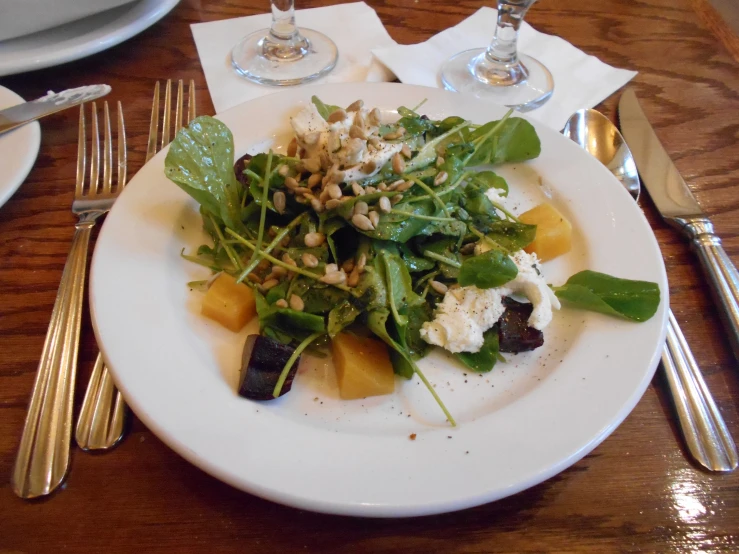 a white plate topped with vegetables on top of a table