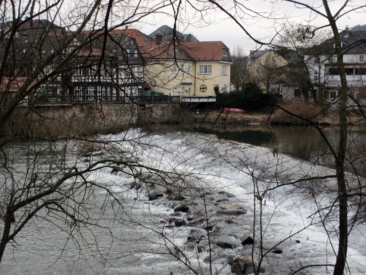 a river runs through the village below a bridge