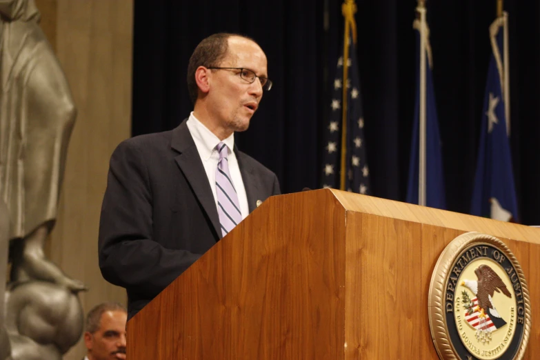 a man standing in front of a podium at a public speech