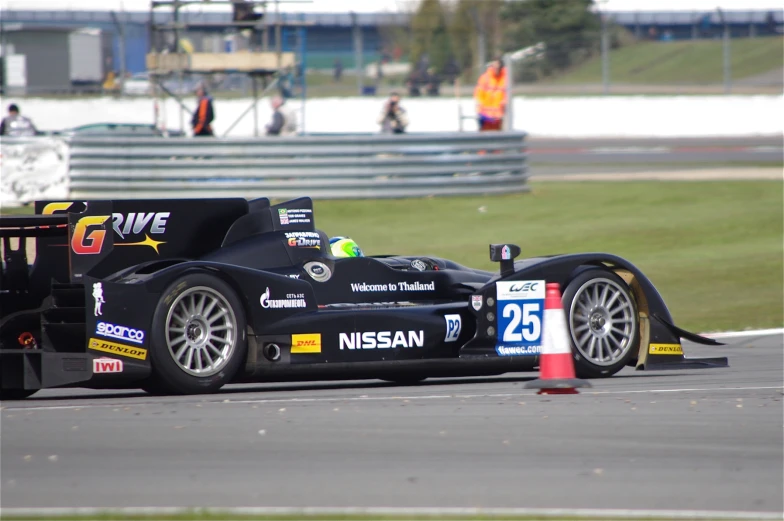 a man driving a racing car around a track