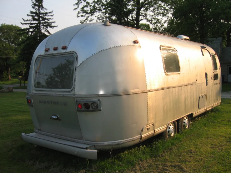 a white trailer that is sitting on some grass