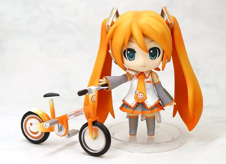 there is a doll with a bike that is standing on a white surface