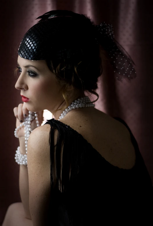 a woman is posing with beads on her neck