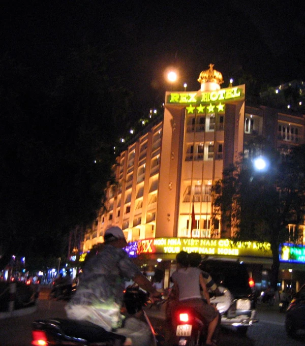 a busy street at night with several motorcycles