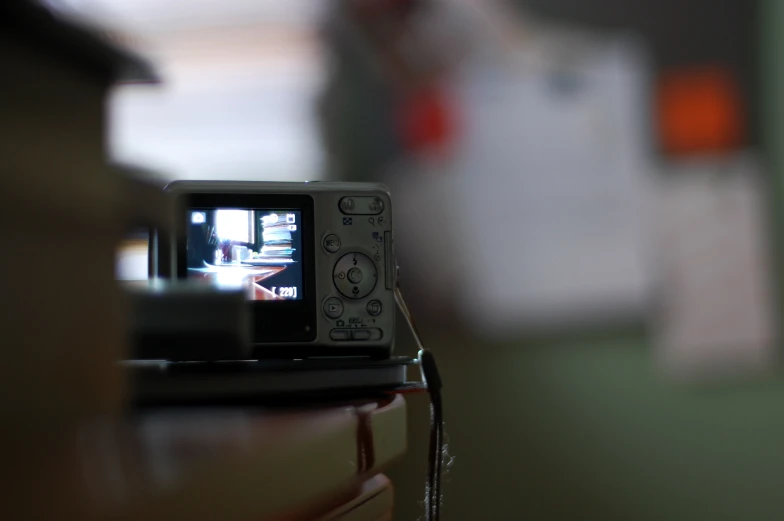 a camera sitting on top of a wooden table