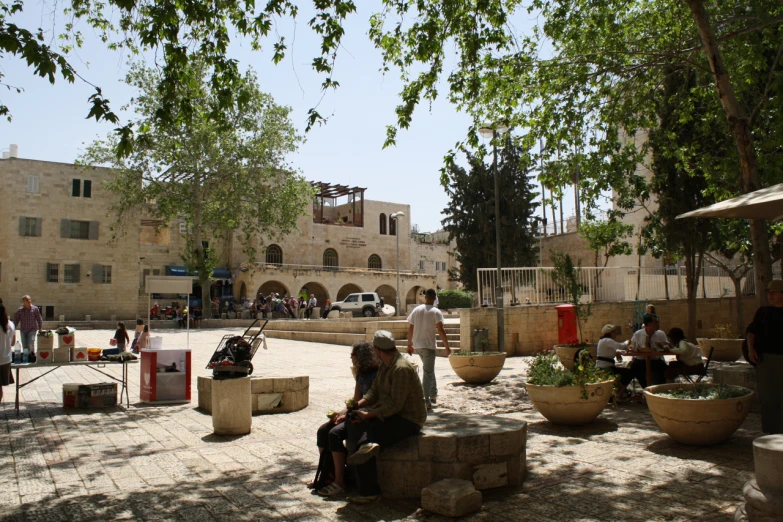 two older men sitting on benches in a courtyard