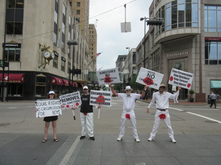 a group of people holding signs in the street