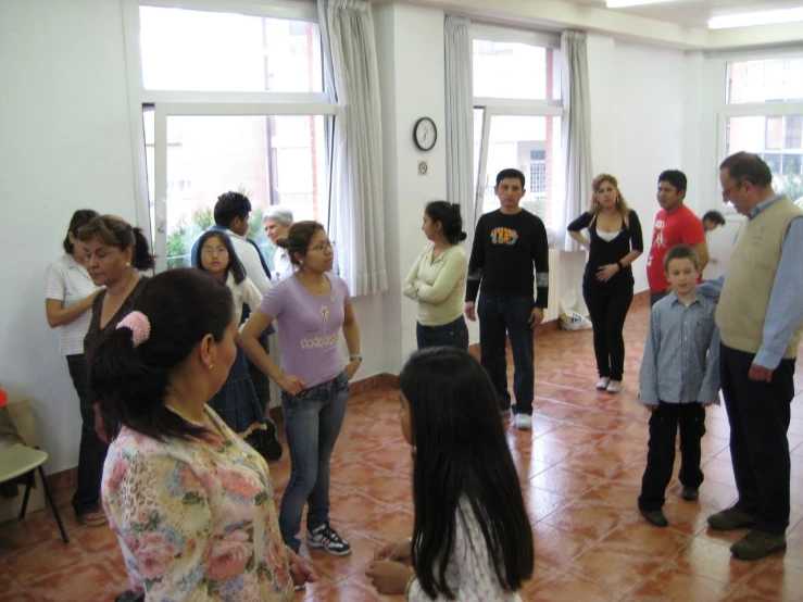 people standing in a room on tiled floors