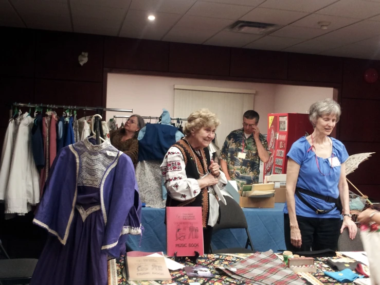 a woman is shopping for clothes at an antique store