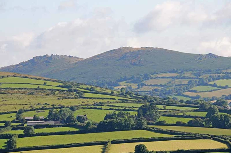 a very big hill with some grass and some hills