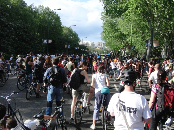 several people in bicycle helmets and bikes on the street