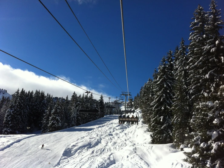 a ski lift is at the top of a snowy slope