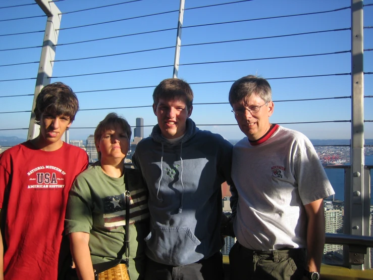 four children posing together for a picture by a railing