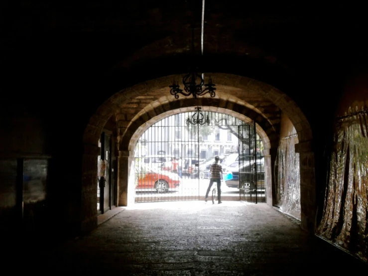 a woman walking out of a doorway with an umbrella