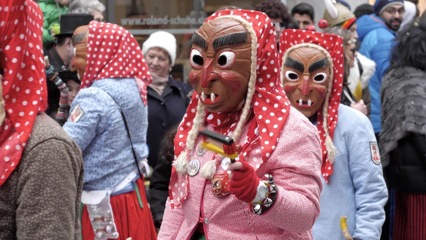 many people are wearing red polka dot heads and masks