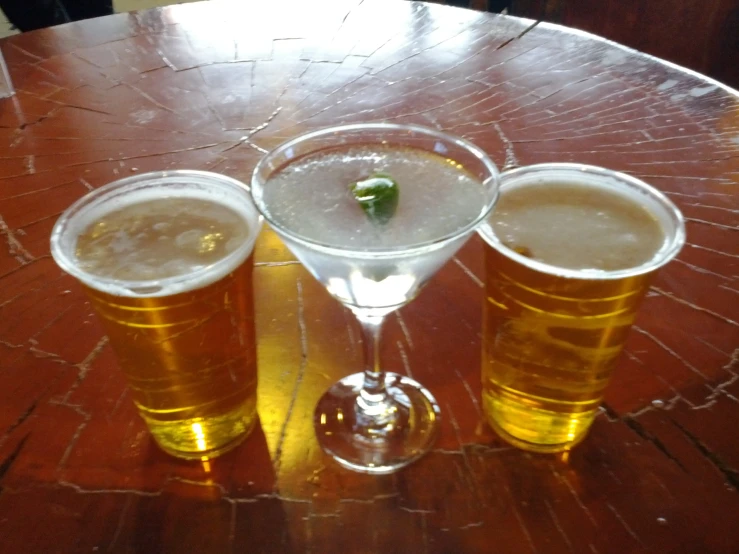 three glasses are stacked together on a table