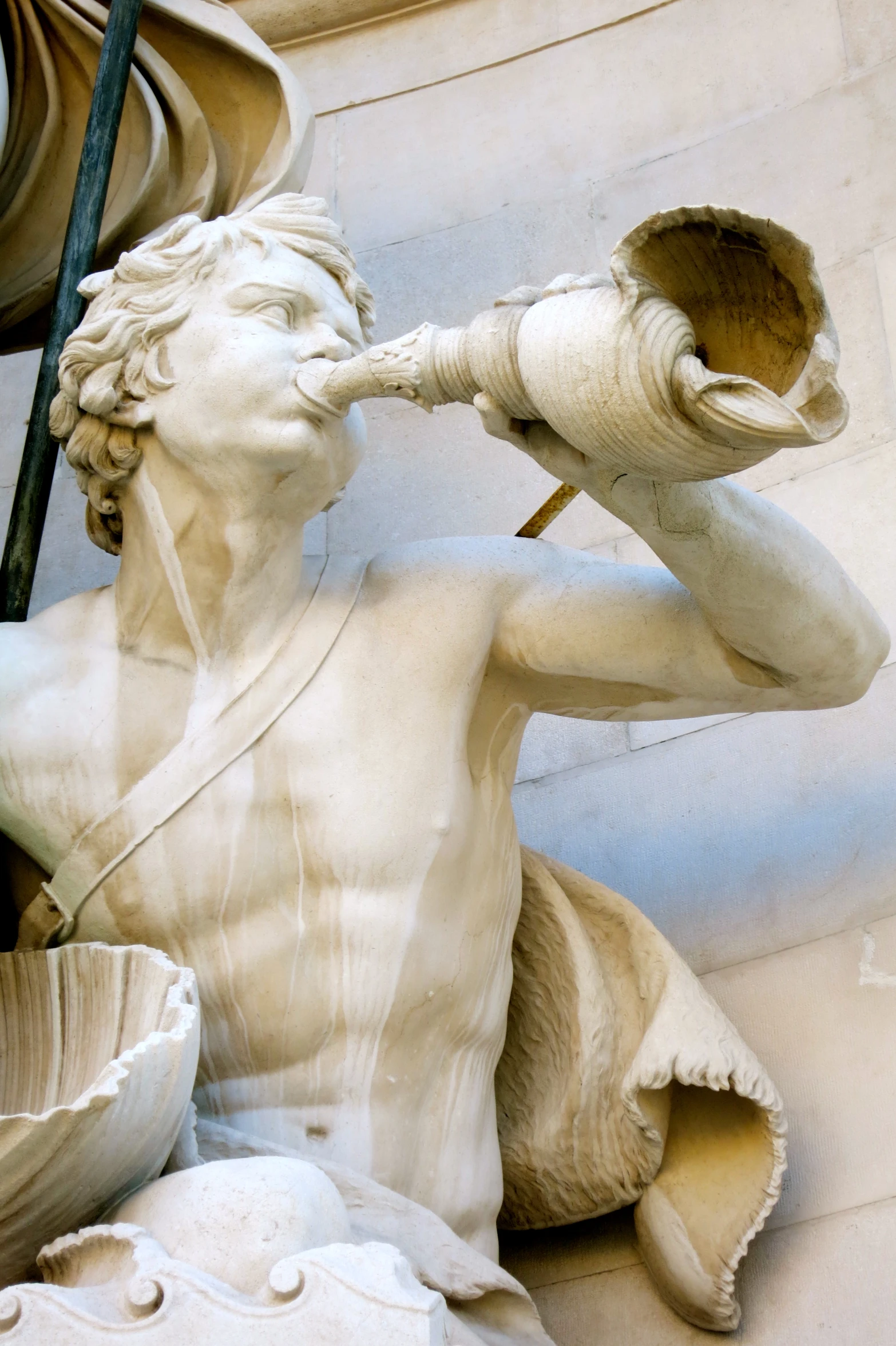 an image of a statue blowing a glass