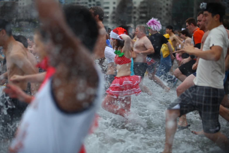 a group of people run into some water