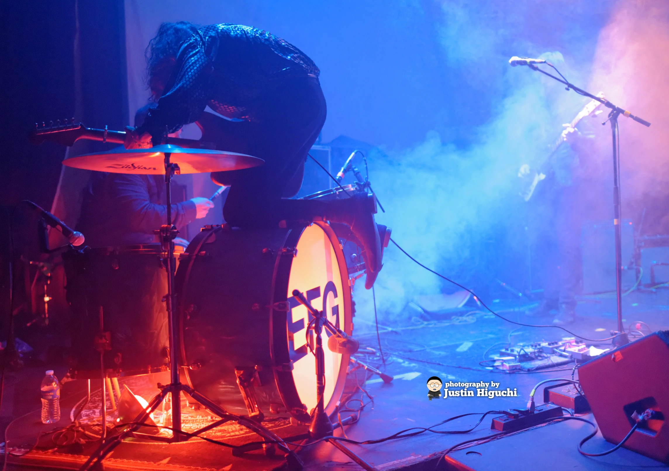 two guys standing around while playing musical instruments