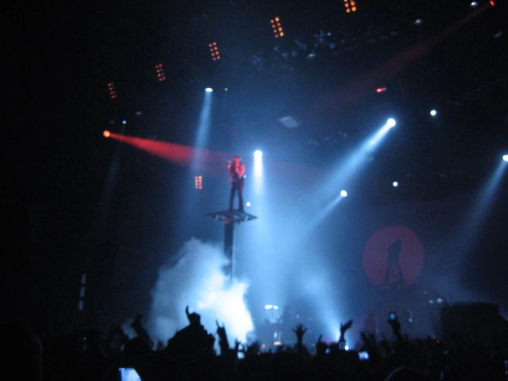 a stage lit with lights and some fans