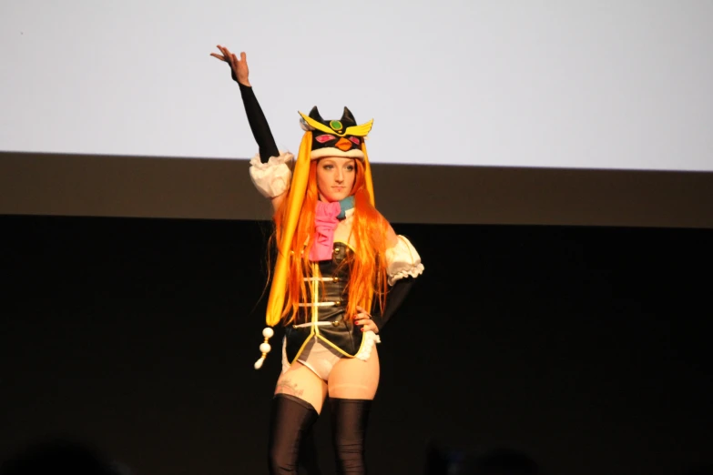 a woman in costume is on stage performing