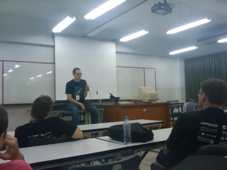 several people in a classroom during a lecture