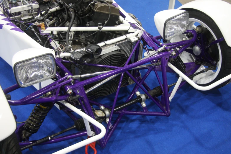 a custom motorcycle is being displayed on a blue carpet