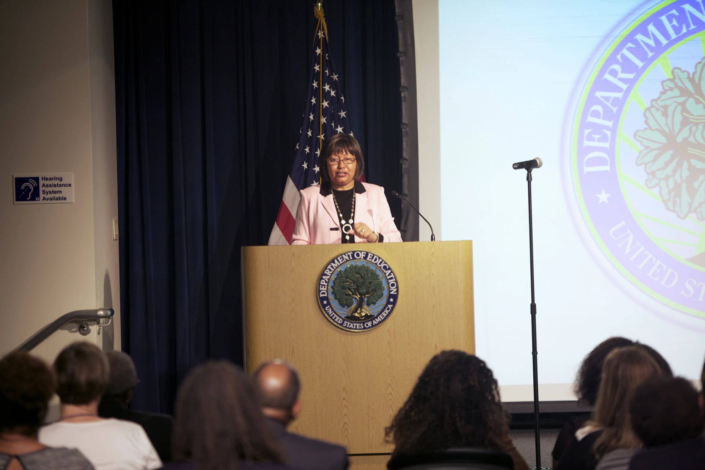 a woman is at the podium giving a speech