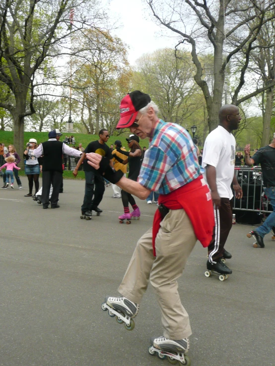 a man skating on a pavement in a park