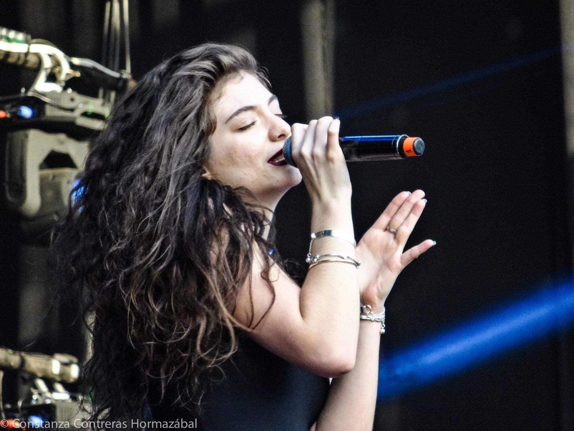 a woman standing up on a stage and singing