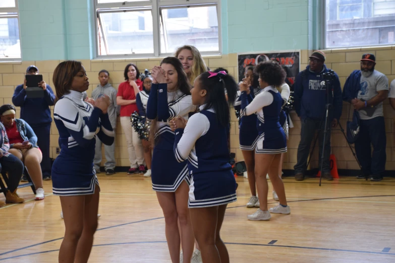 cheerleaders on the gym floor at school during competition