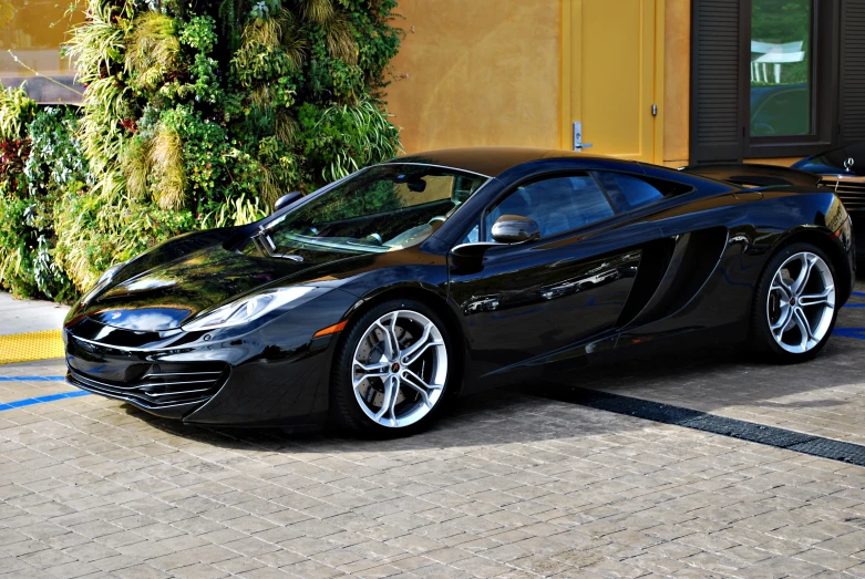 a sports car is parked outside of a shop