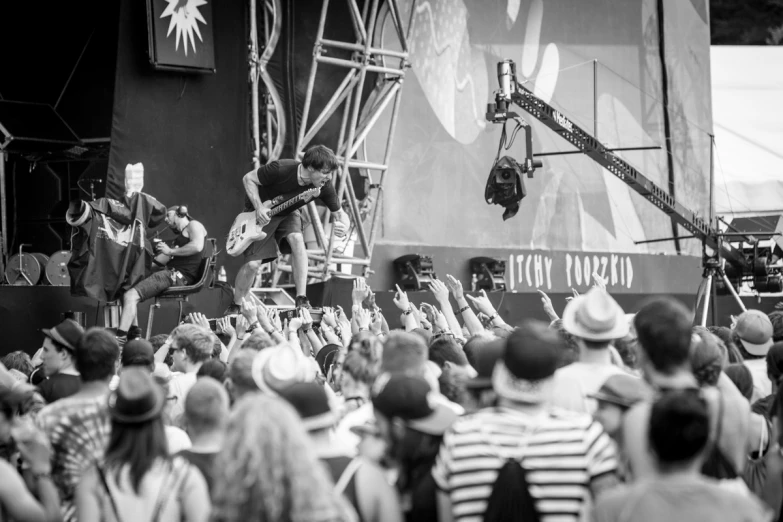 black and white pograph of people playing music on stage