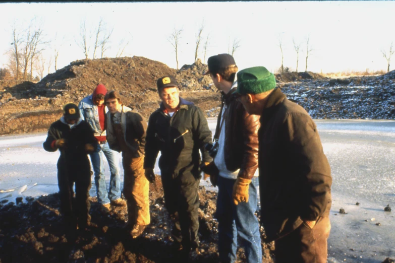 some boys in a field with some dirt