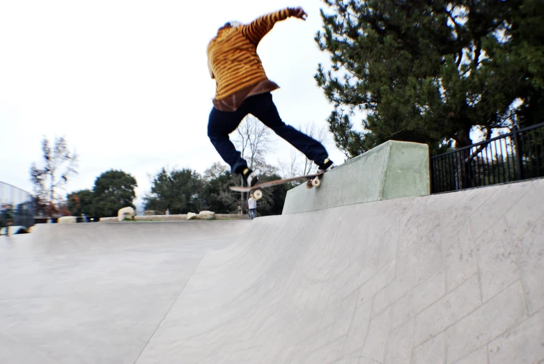 a skateboarder doing tricks on a ramp while people watch