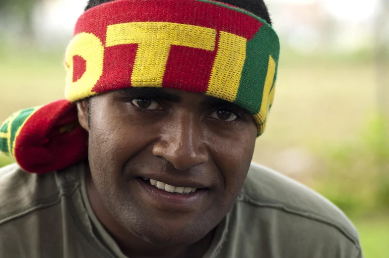 a man wearing a hat with the word etf in red, yellow and green