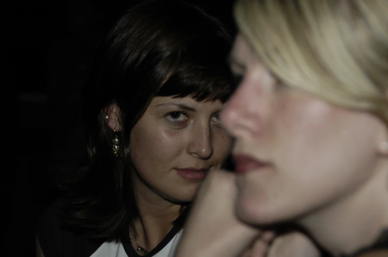 a close up of two people looking at the camera