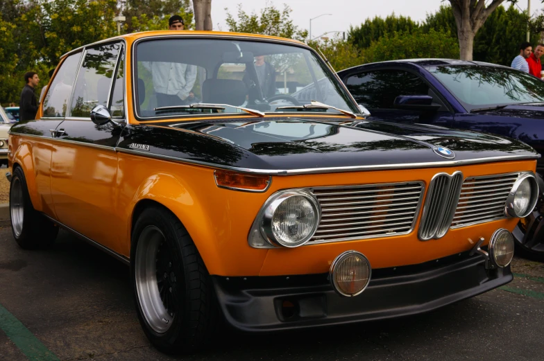 this is an orange and black car that looks old