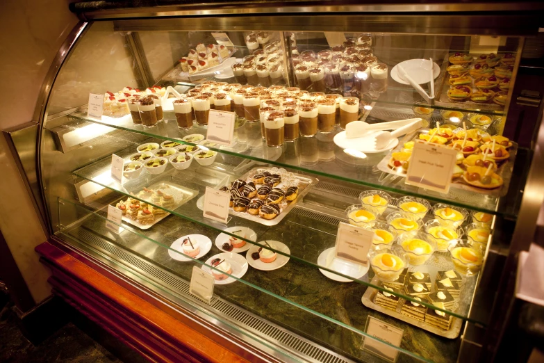 various pastries on display in a bakery with labels