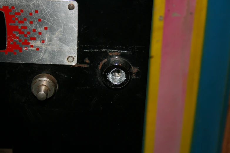 close up of a metallic door with colorful background