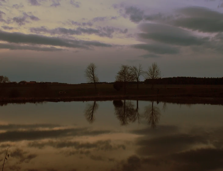 a picture of a cloudy sky and some water