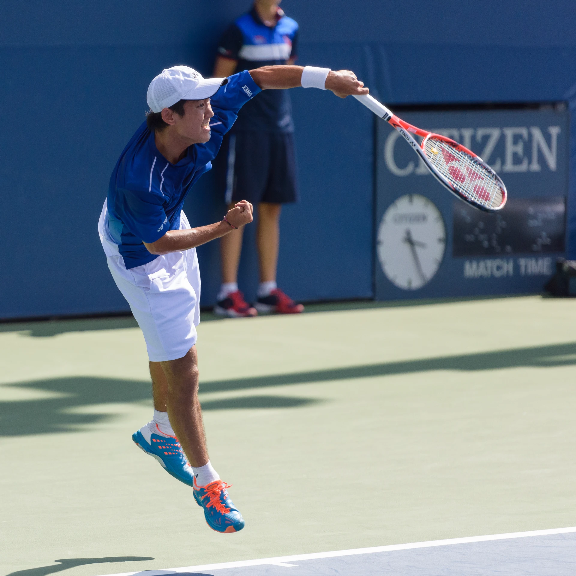 a man jumping with a tennis racket on a court