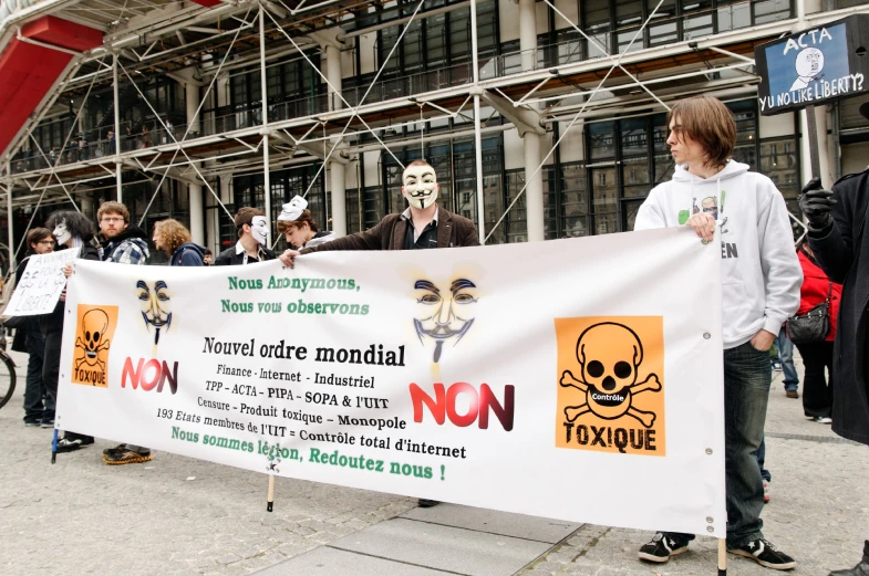 a group of people stand together with signs