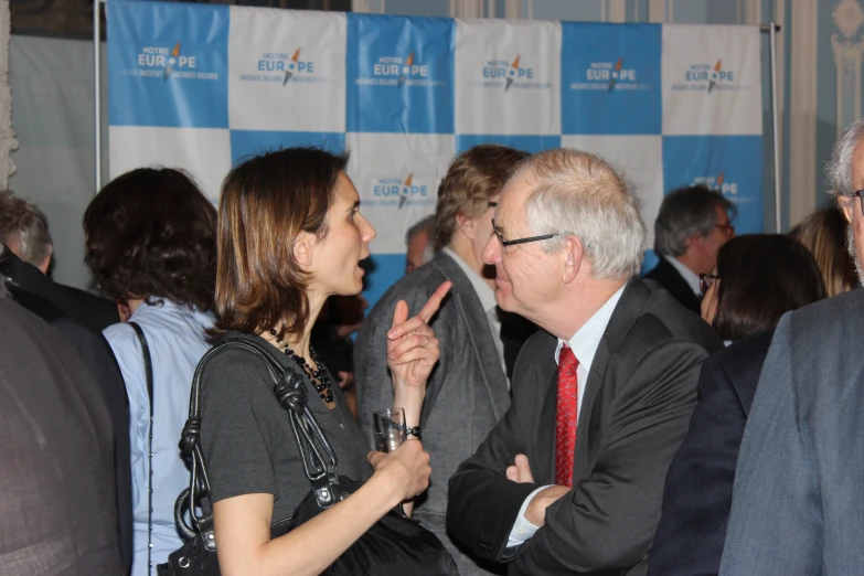 a man and a woman sharing a hug at a corporate event