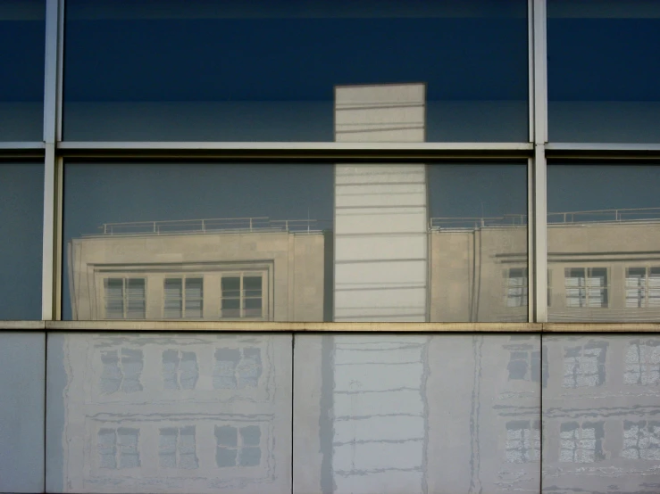 a reflection of a building in a window