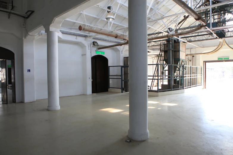 a large open space with two white pillars and white painted walls