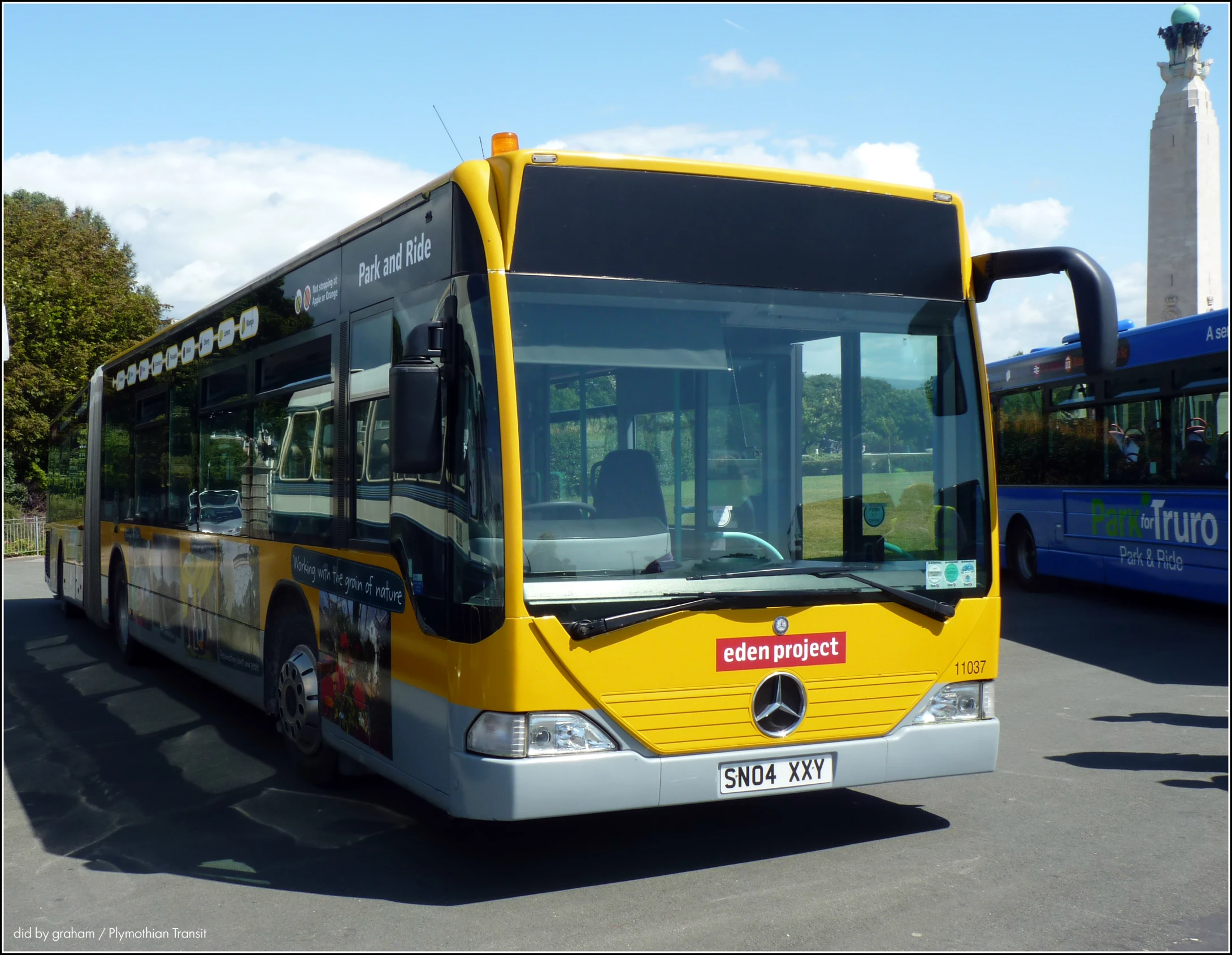 the front of a passenger bus stopped at the curb